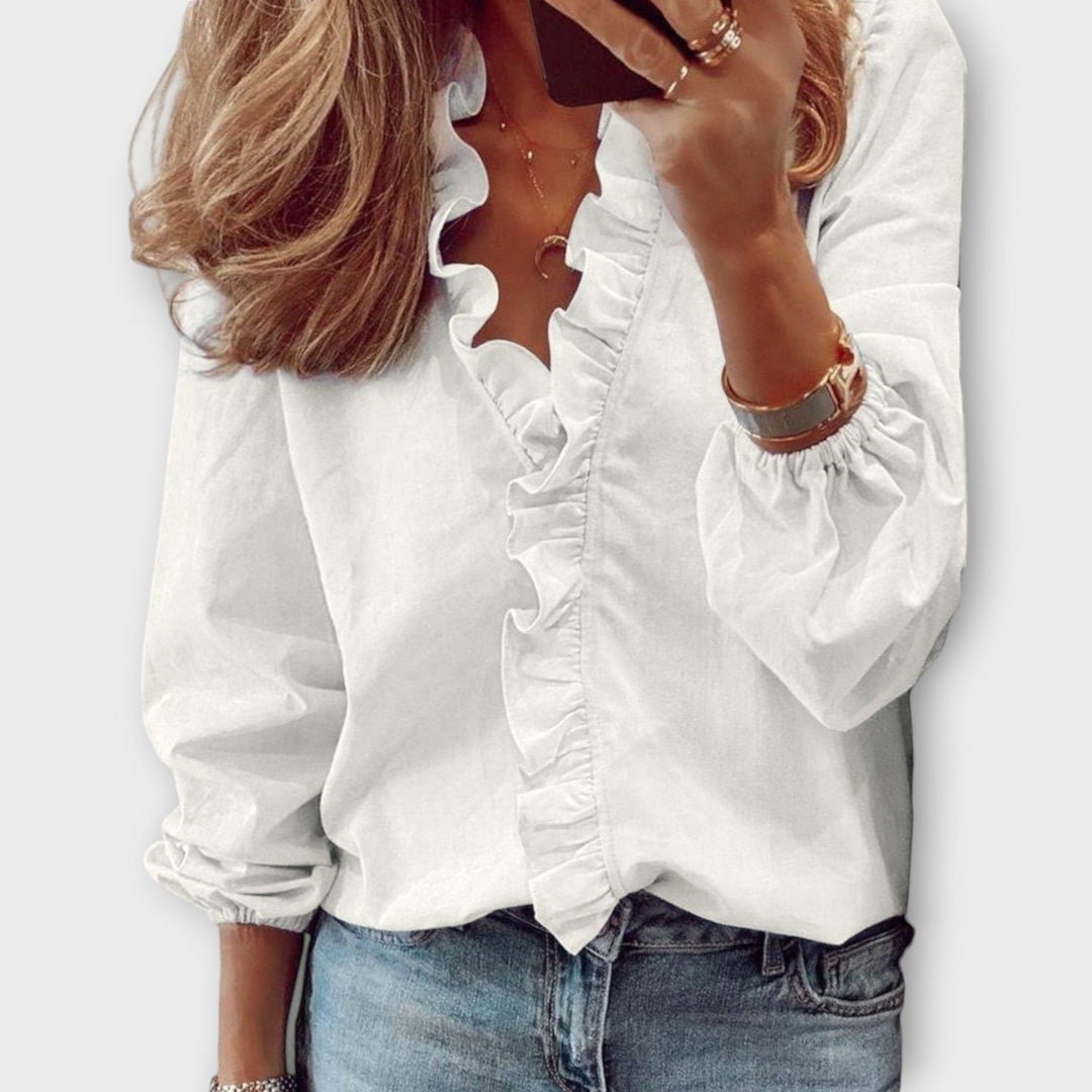 Elegant women's ruffled summer blouse in a soft fabric, perfect for sophisticated style or office wear. Lightweight and chic.