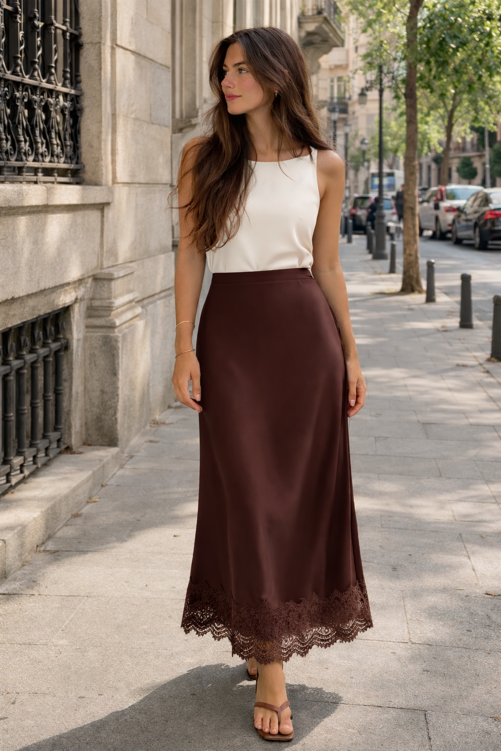 Close-up of the intricate lace hem on a luxurious women's satin finish maxi skirt, highlighting its elegant detail.