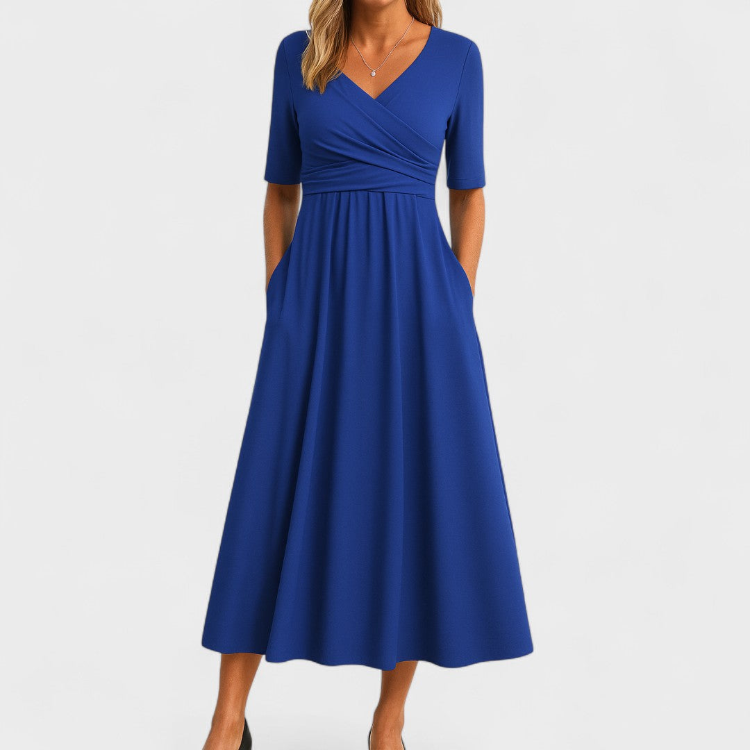Close-up of elegant women's wrap dress showing flattering V-neckline and stylish 3/4 sleeves.