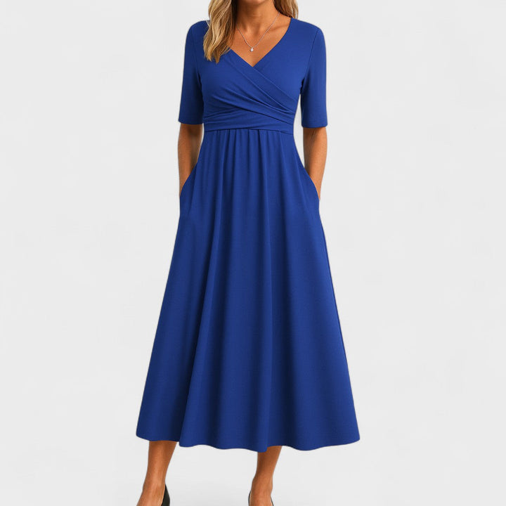 Close-up of elegant women's wrap dress showing flattering V-neckline and stylish 3/4 sleeves.