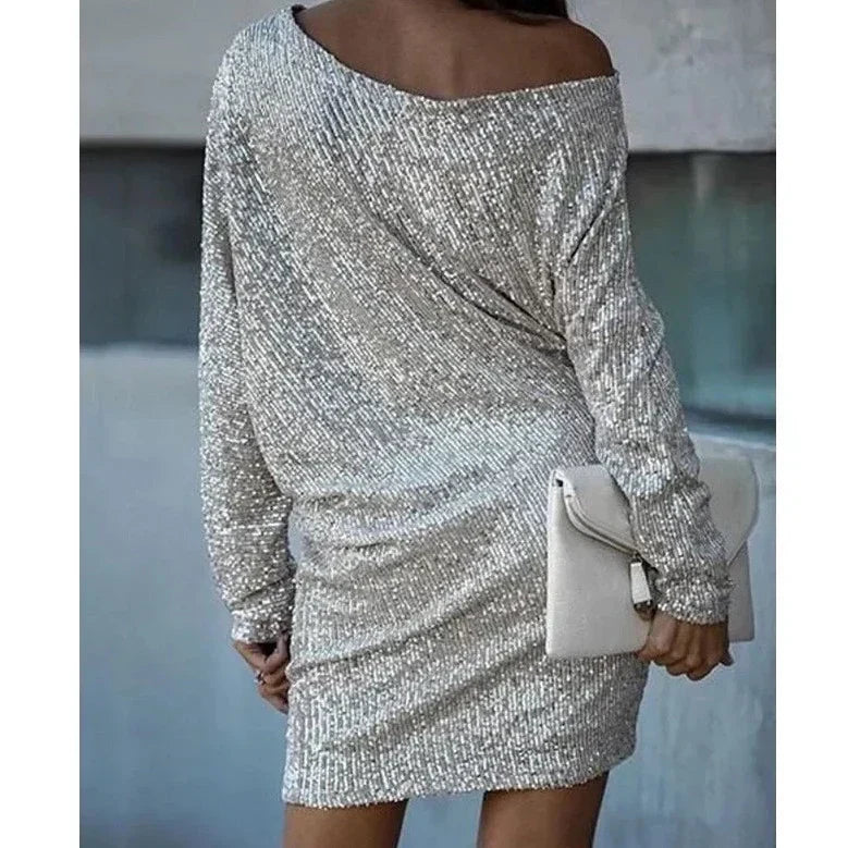 Close-up of shimmering sequins on an elegant women's mini party dress, perfect for holiday events.