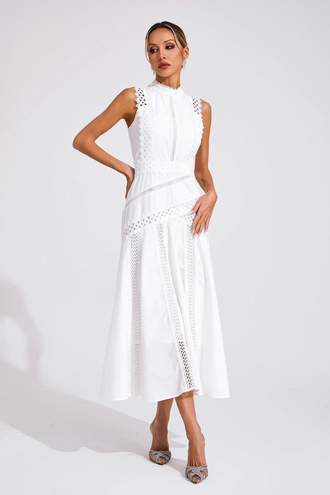 Feminine women's midi dress featuring intricate lace paneling & a sleeveless design for an elegant look.