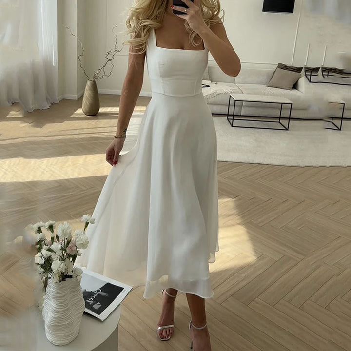 Chic women's square neck midi dress, ideal for formal events, summer parties & evening wear. Elegant and sleeveless.