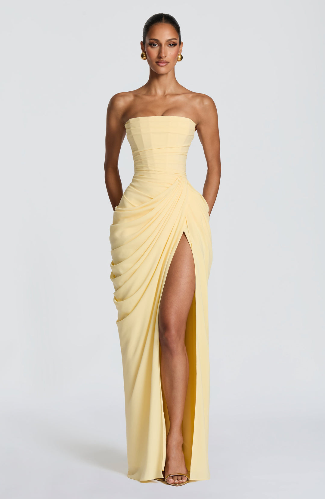 Elegant women's strapless maxi dress with corset bodice, draped waist, and leg split for special occasions.
