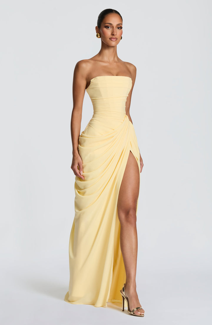 Vibrant yellow strapless maxi dress for women, featuring a chic corset bodice and daring leg split.