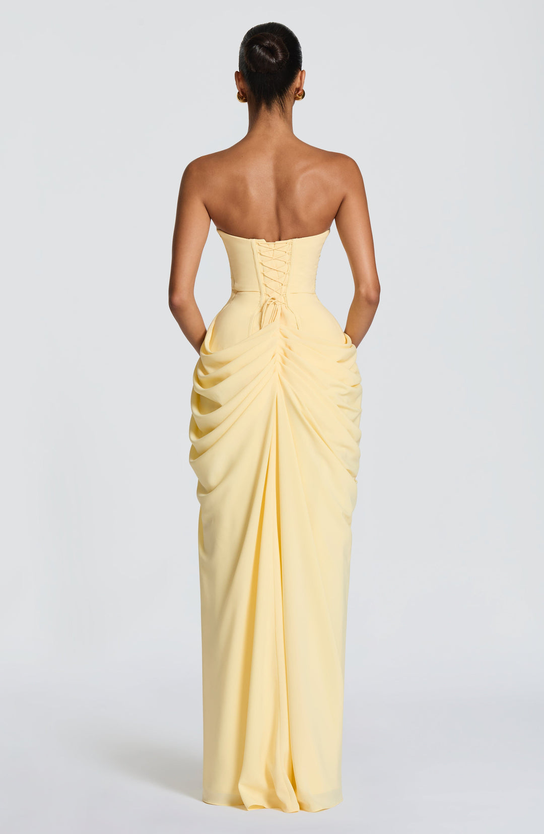 Dark blue women's evening gown. Strapless design with corset bodice, draped waist, and stylish leg split.