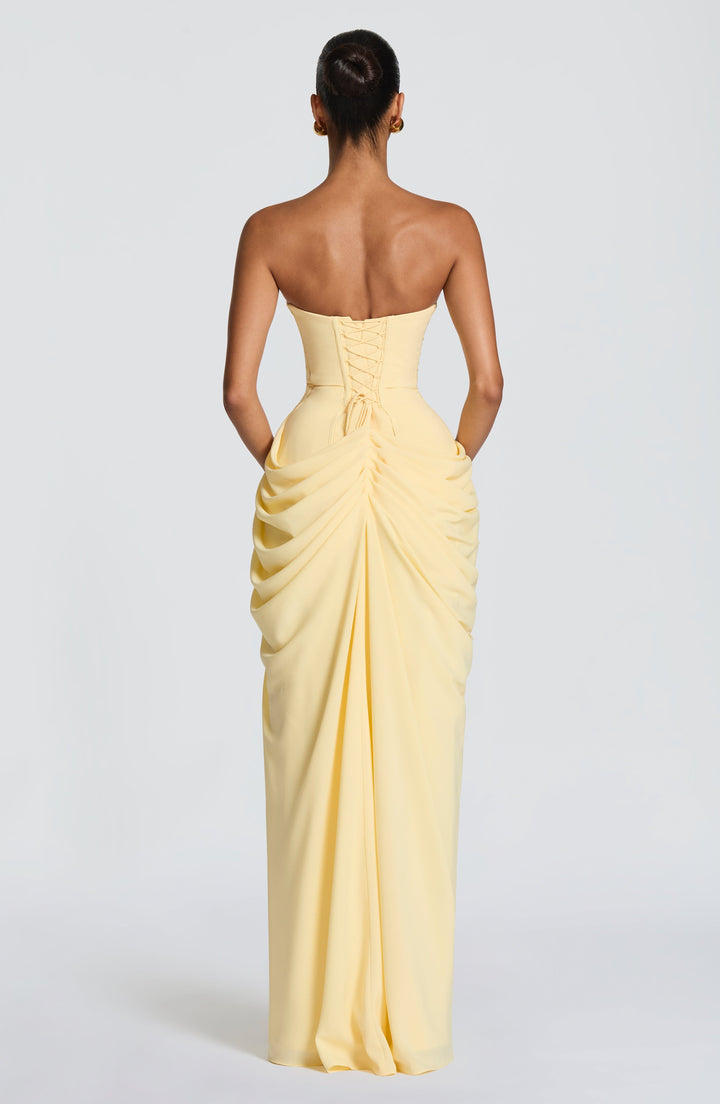 Dark blue women's evening gown. Strapless design with corset bodice, draped waist, and stylish leg split.