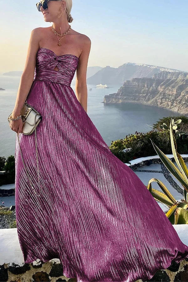 Elegant women's strapless pleated maxi dress in motion, showcasing its flowy skirt and formal design.