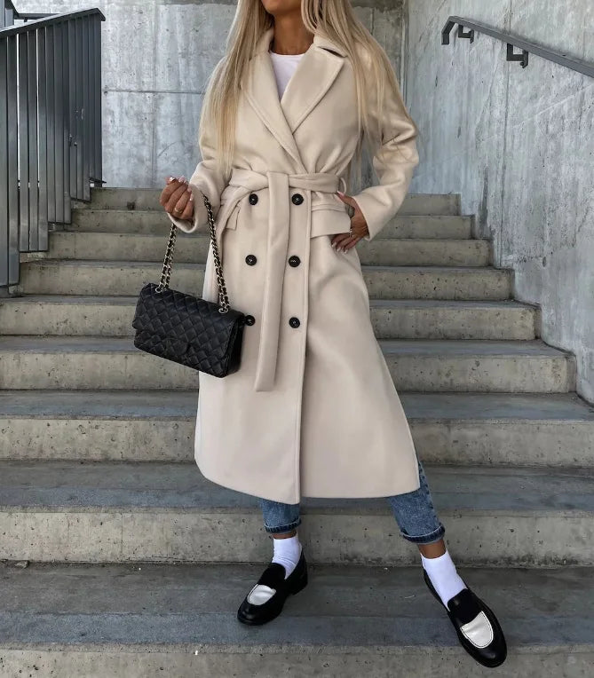 Elegant women's tailored long coat with a stylish belt, perfect for office wear and professional autumn fashion.