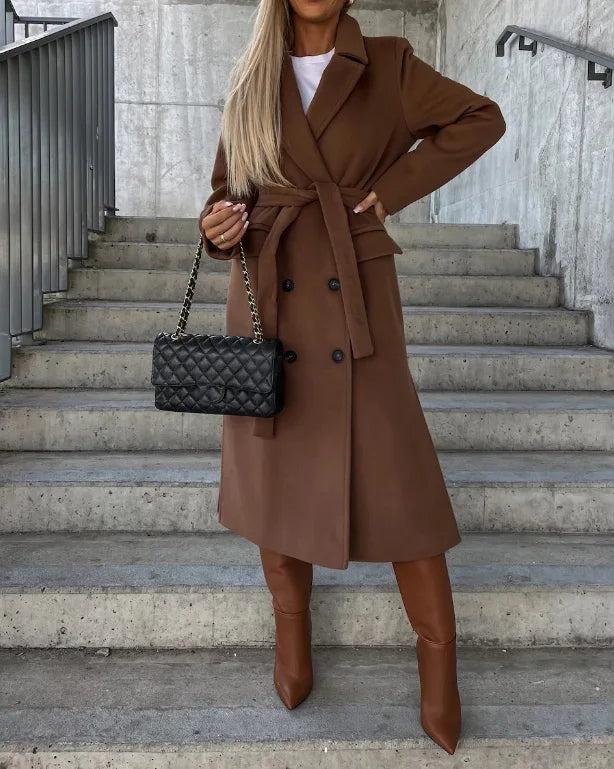 Stylish women's long trench coat, a chic belted jacket offering sophisticated style for autumn and winter fashion.