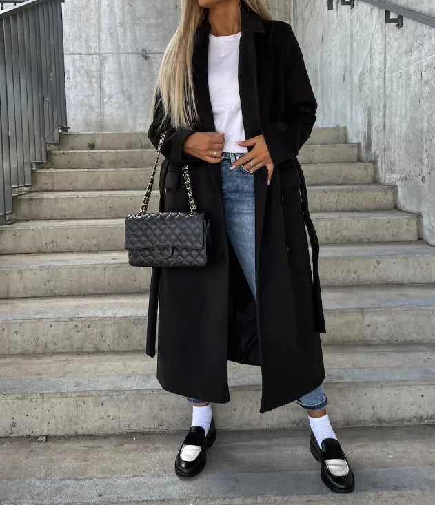 Structured women's belted long coat, versatile elegant outerwear for professional settings and stylish everyday wear.