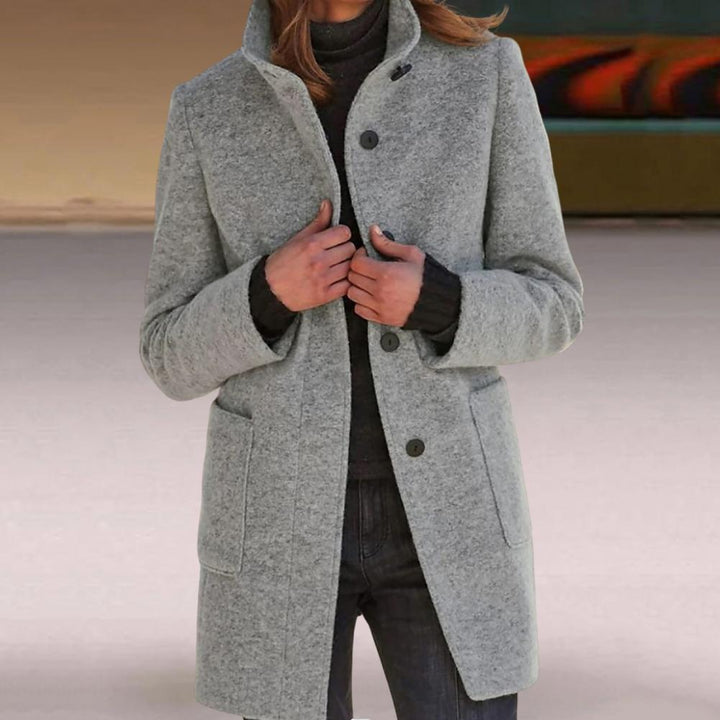 Modern women's tailored mid-length coat, an elegant outerwear piece with button details for chic fall style.