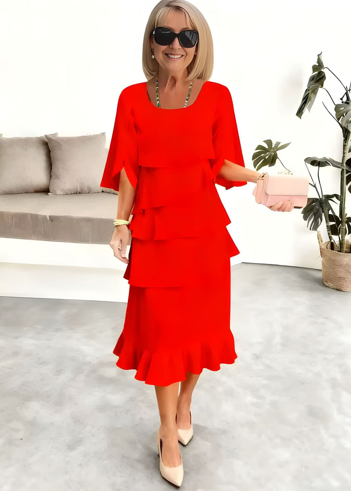 Chic women's tiered midi dress featuring stylish ruffles, round neck, and trendy flared sleeves for summer.