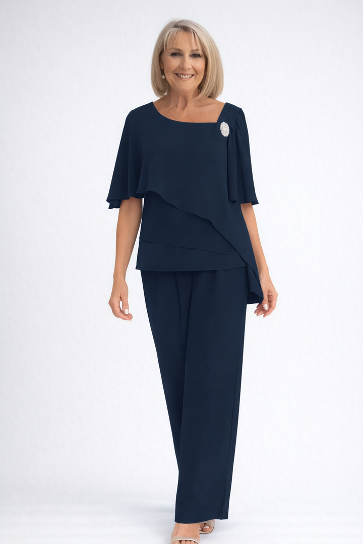 Chic women's formal two-piece set with a flowing cape top and tailored trousers. Ideal for special events.