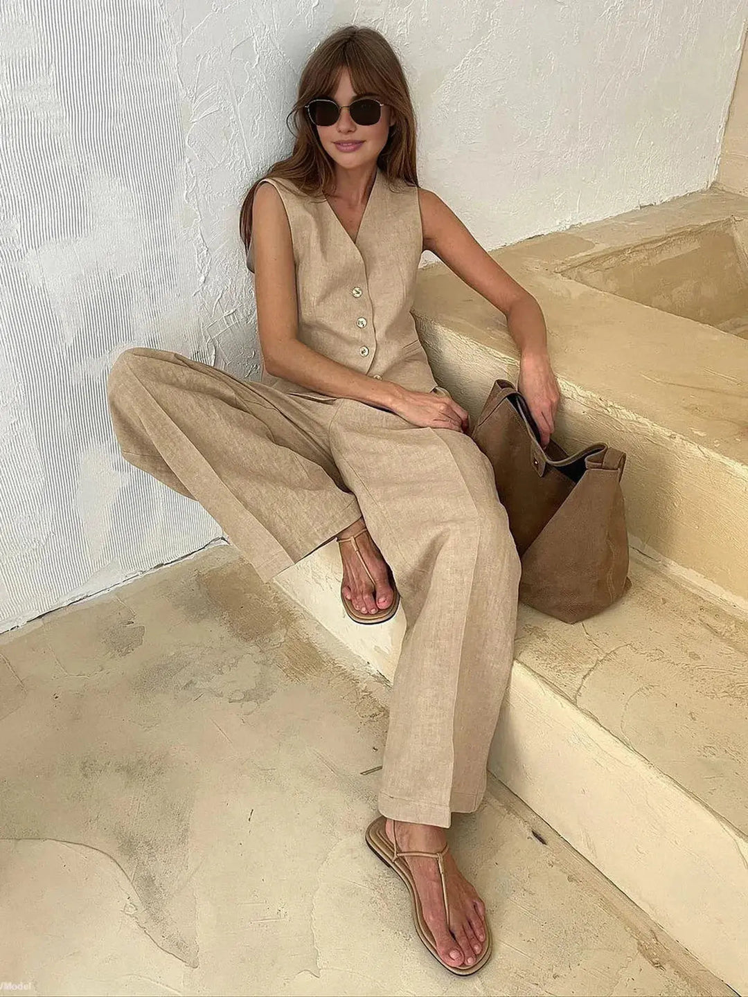 Modern women's summer outfit: a relaxed-fit waistcoat paired with fashionable wide-leg pants for a chic look.