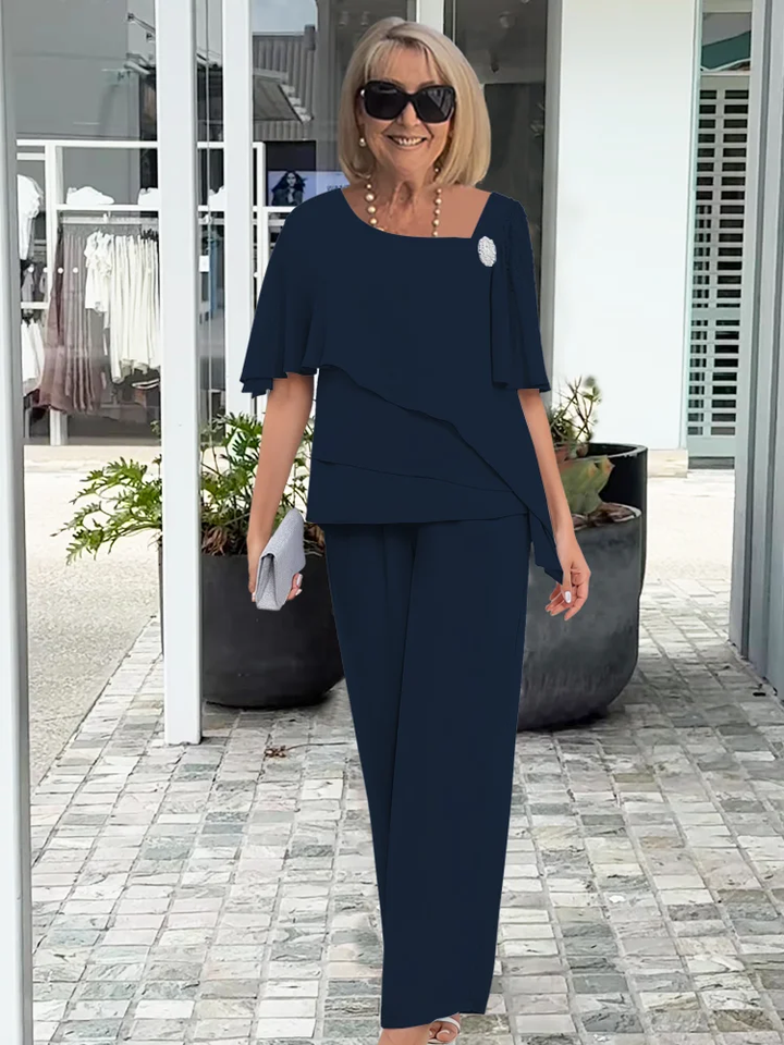 Chic women's trouser set with a cape top & wide-leg pants. Versatile smart casual or event attire ensemble.