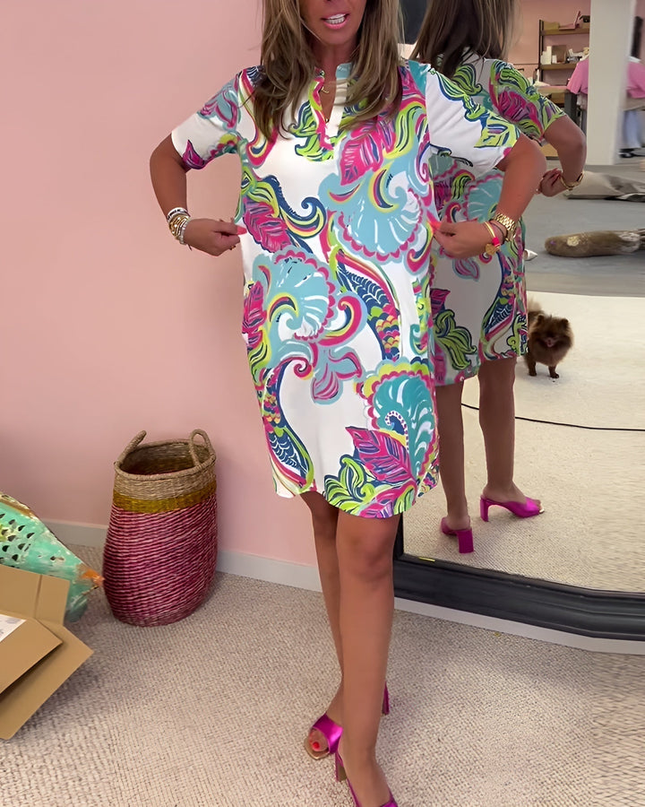 Elegant women's V-neck draped midi dress with a beautiful print. A chic and flattering summer style.