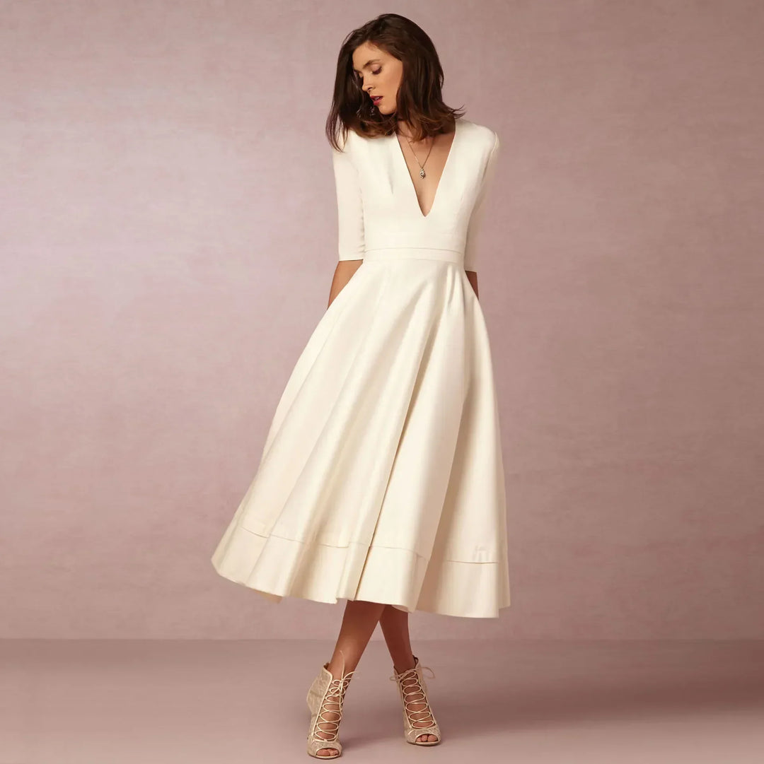Elegant women's V-neck elbow-sleeve midi dress, perfect for sophisticated day-to-night style. Timeless fashion.