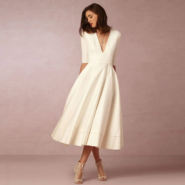 Elegant women's V-neck elbow-sleeve midi dress, perfect for sophisticated day-to-night style. Timeless fashion.