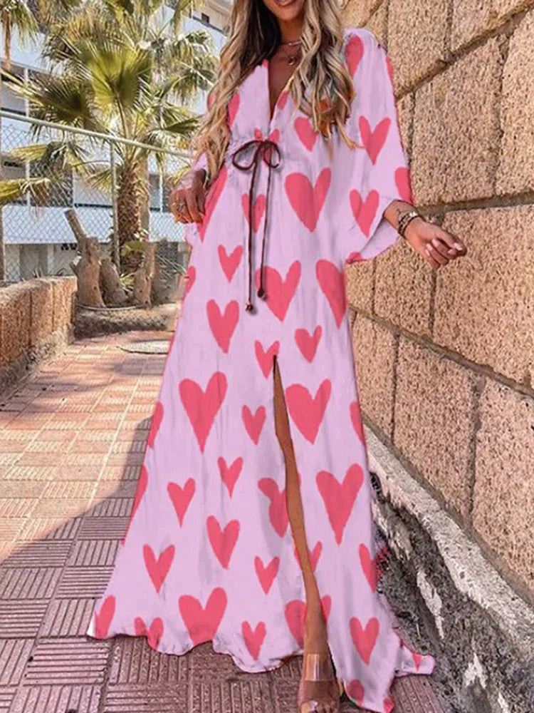 Detailed shot of a women's V-neck maxi dress, highlighting flowy kimono sleeves and the elegant high slit design.
