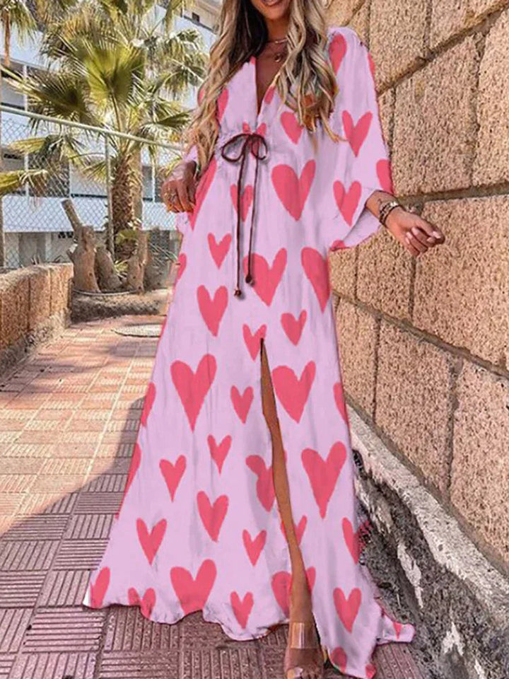 Detailed shot of a women's V-neck maxi dress, highlighting flowy kimono sleeves and the elegant high slit design.