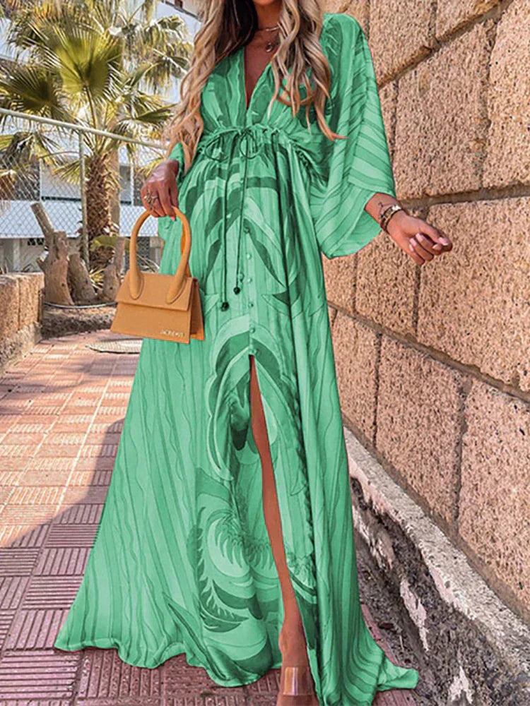 Fashionable women's V-neck maxi dress with elegant kimono sleeves and a high slit, showcasing its flowy silhouette.