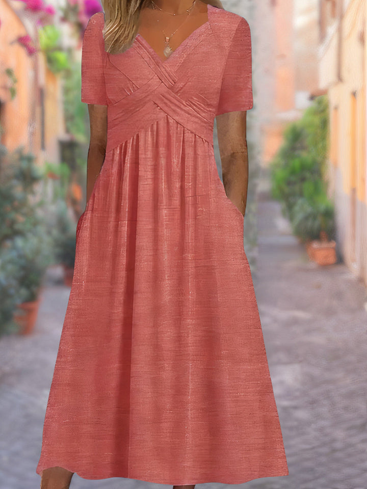 Stylish women's spring/summer midi dress with an elegant V-neck and unique crisscross design.