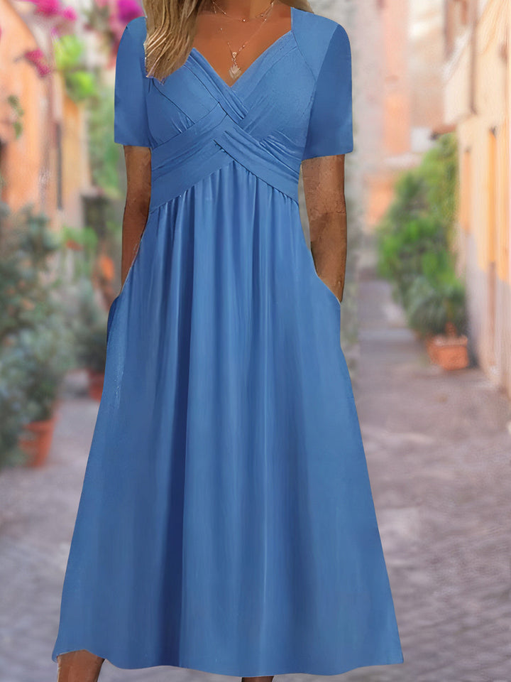 Comfortable yet elegant women's V-neck midi dress with a unique crisscross front, perfect for everyday or special events.