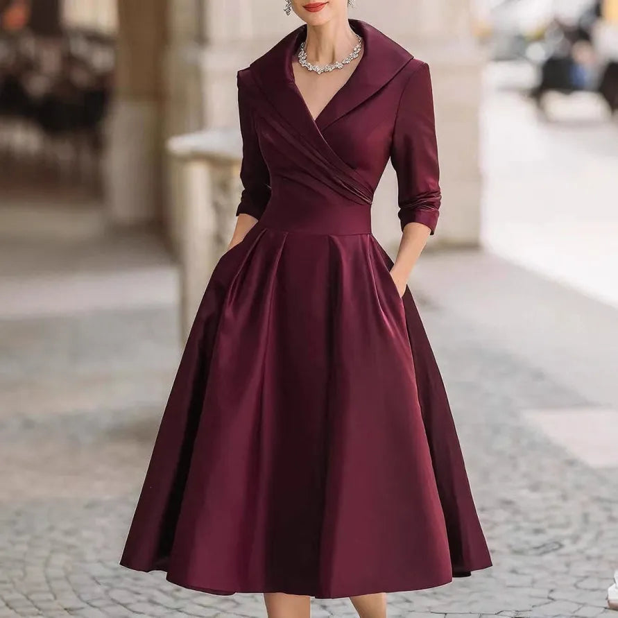 Women's midi dress featuring a V-neck, three-quarter sleeves & flared skirt. An elegant choice for sophisticated fashion.