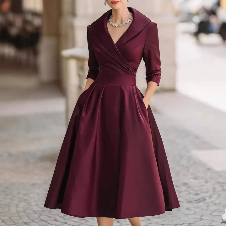 Women's midi dress featuring a V-neck, three-quarter sleeves & flared skirt. An elegant choice for sophisticated fashion.