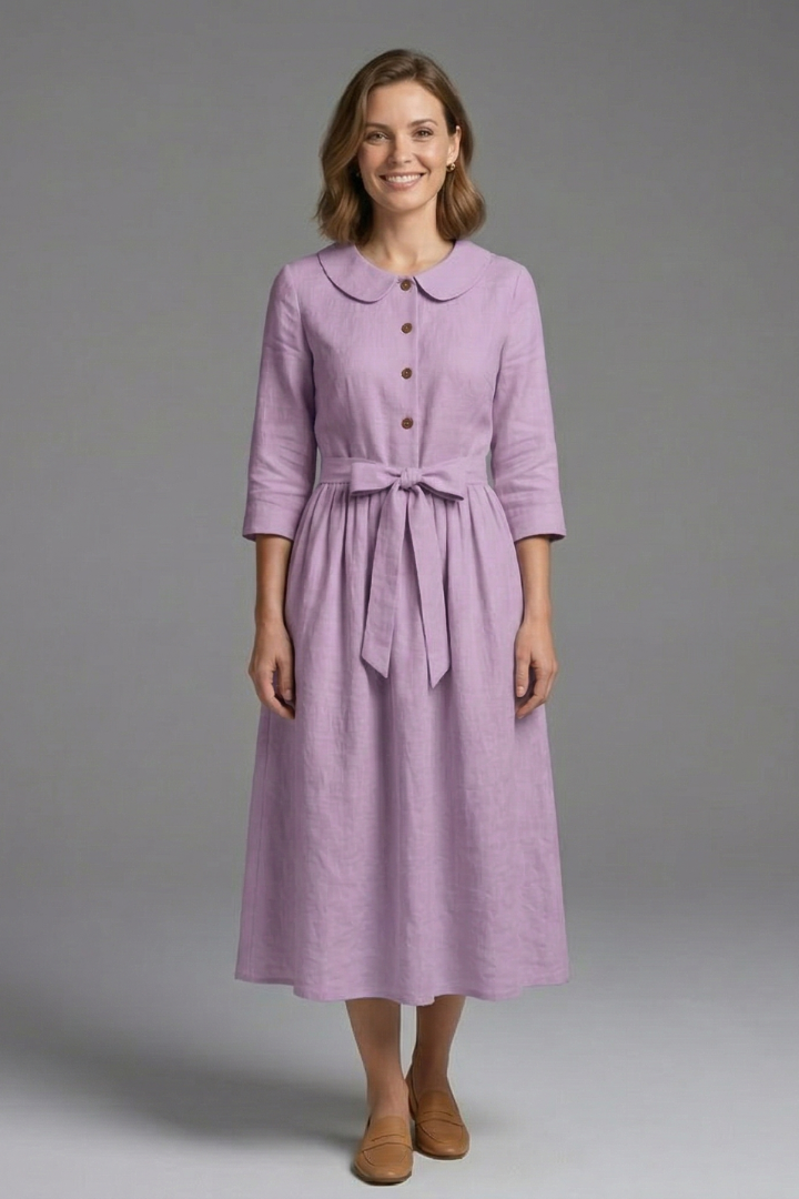 Woman twirling in flowing V-neck midi dress with waist tie, highlighting elegant & flattering fit.