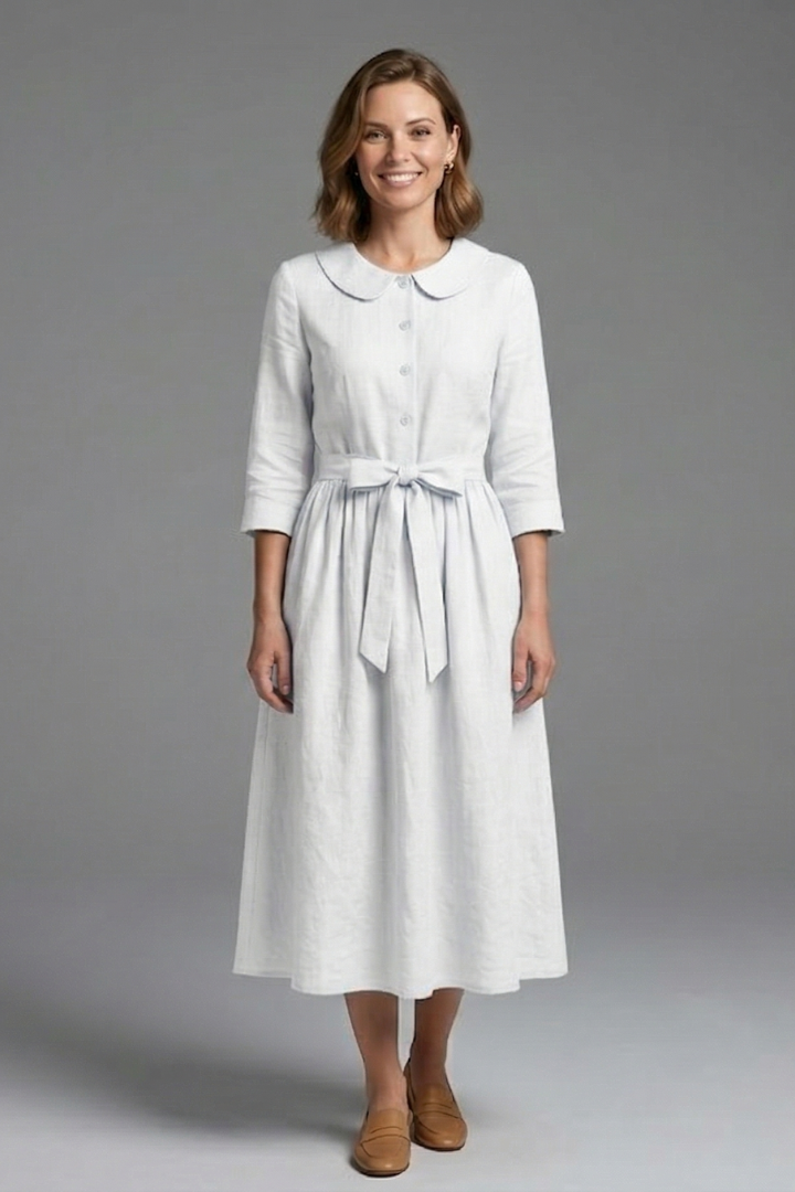 Woman in sophisticated V-neck midi dress with waist tie, perfect for evening events.