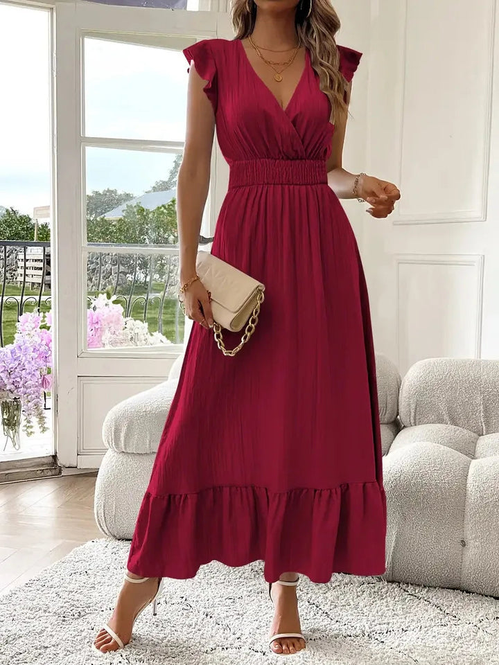 Full-length view of a woman wearing a flowy V-neck ruffle maxi dress, showcasing its elegant comfort for spring/summer.