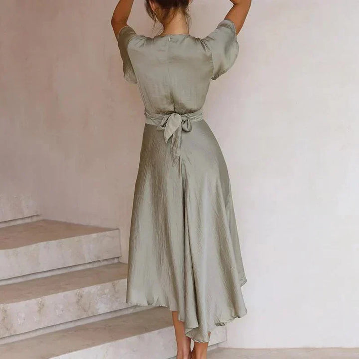 Close-up of a stylish V-neck tie front midi dress, highlighting delicate flutter sleeves and design.