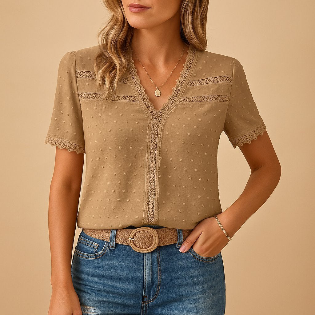 Elegant women's V-neck top featuring delicate lace trim and subtle textured Swiss dots, perfect for spring/summer style.
