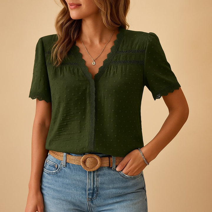 Detailed view of a feminine short-sleeve V-neck blouse, showcasing delicate lace trim and trendy textured Swiss dots.