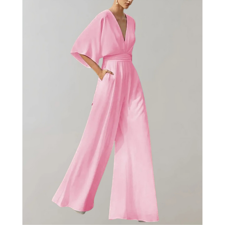 Woman in elegant V-neck wide leg jumpsuit, posing. Perfect evening and formal wear for special events.