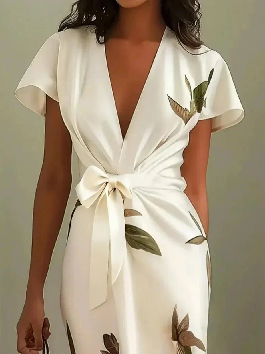 Chic women's V-neck wrap midi dress featuring a beautiful botanical print, flutter sleeves & tie waist.
