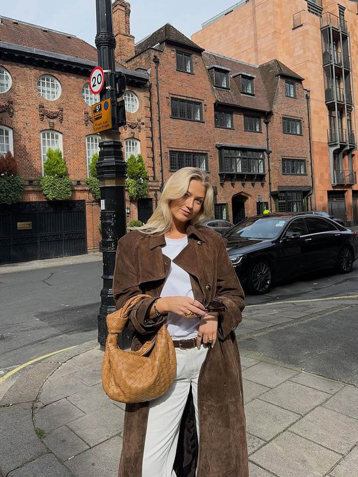 Full-length image of a women's belted trench coat, showcasing its elegant design and warmth.
