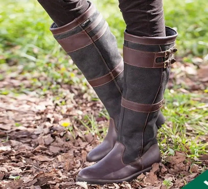 Elegant women's waterproof knee-high pull-on boots with buckles, perfect for all-weather comfort & country style.