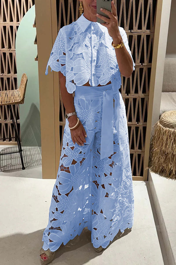 Chic women's eyelet two-piece outfit featuring ruffle sleeves, ideal for a garden party or elegant summer events.