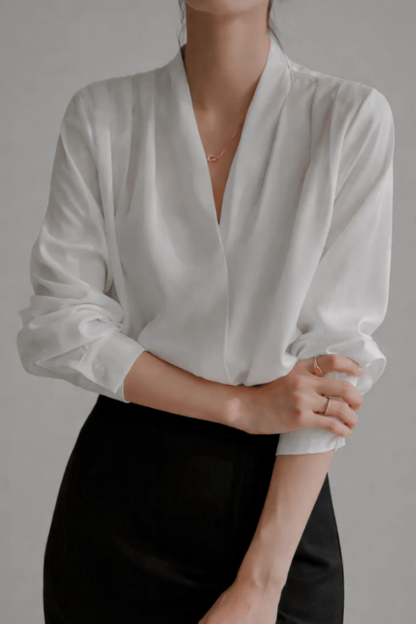 Elegant women's white wrap blouse with long sleeves, perfect for versatile everyday and workwear chic style.