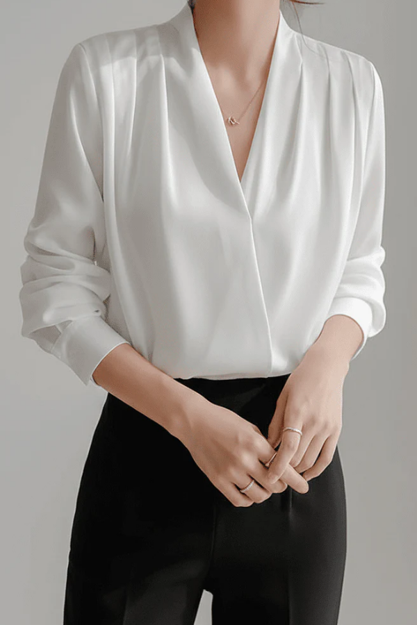 Women's versatile wrap blouse in white, featuring a flattering design for effortless everyday and work fashion.