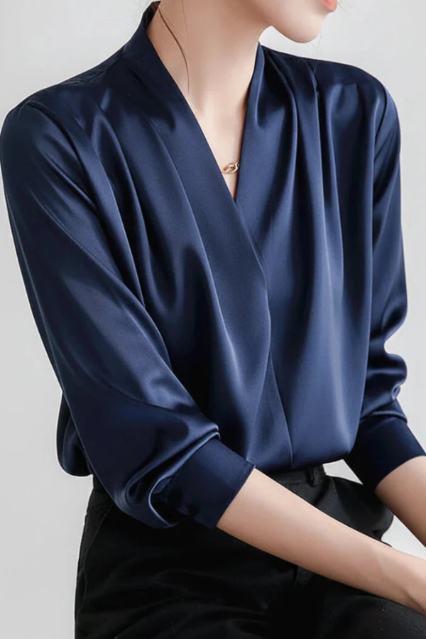 Stylish women's long-sleeve wrap top, an elegant blue blouse designed for comfortable everyday and professional wear.