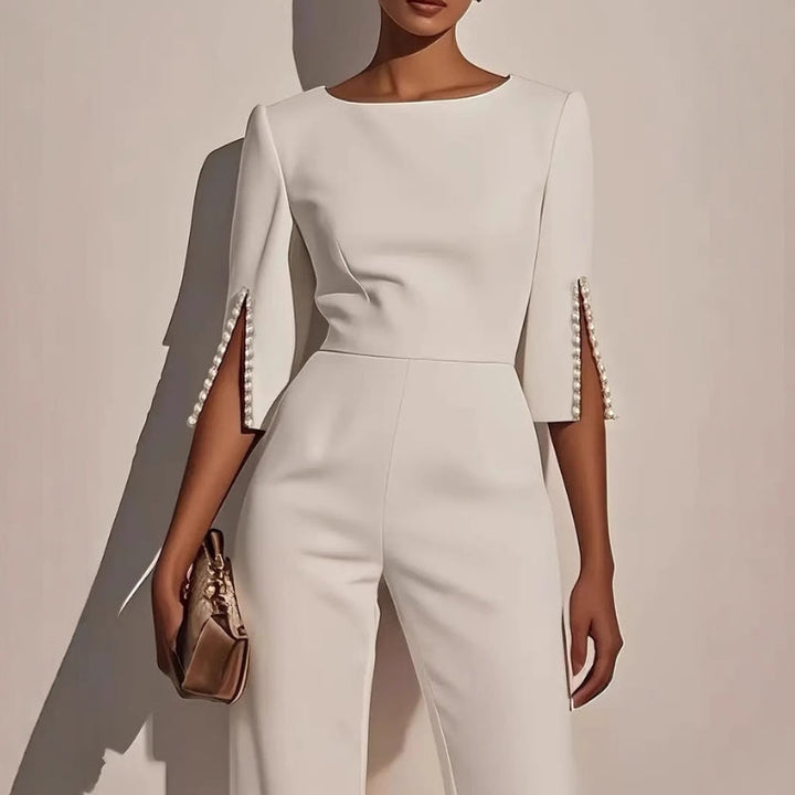 Comfortable women's wide leg jumpsuit. Relaxed fit one-piece with elegant pearl detail, versatile for casual wear.