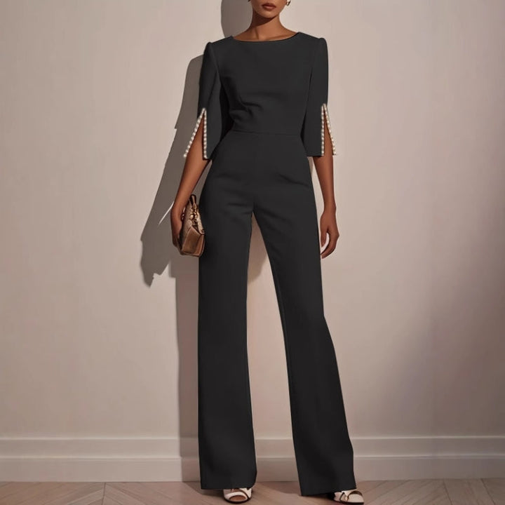 Fashionable wide leg jumpsuit for women, featuring chic pearl accents and a stylish, flowing silhouette.