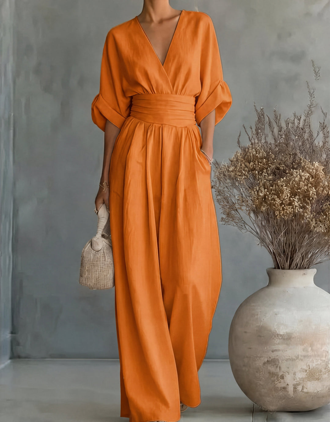 Fashionable women's elegant wide-leg wrap jumpsuit, perfect as a comfortable evening outfit.
