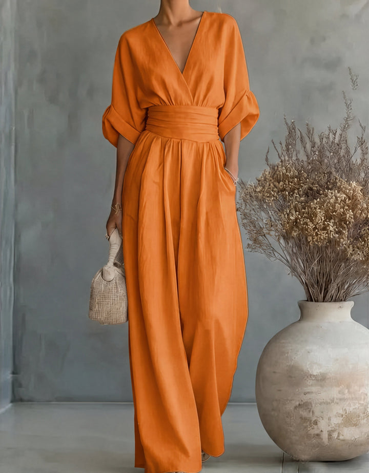 Fashionable women's elegant wide-leg wrap jumpsuit, perfect as a comfortable evening outfit.