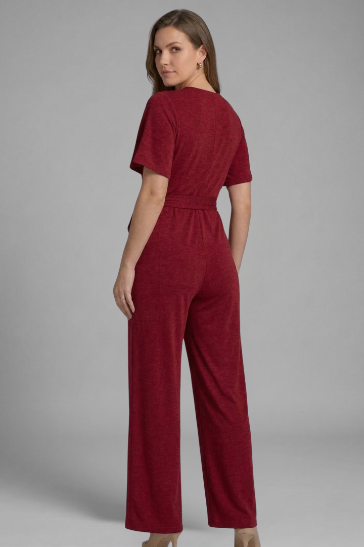 Flattering women's wrap front jumpsuit with a defined tie waist and elegant wide-leg silhouette. Short sleeve.