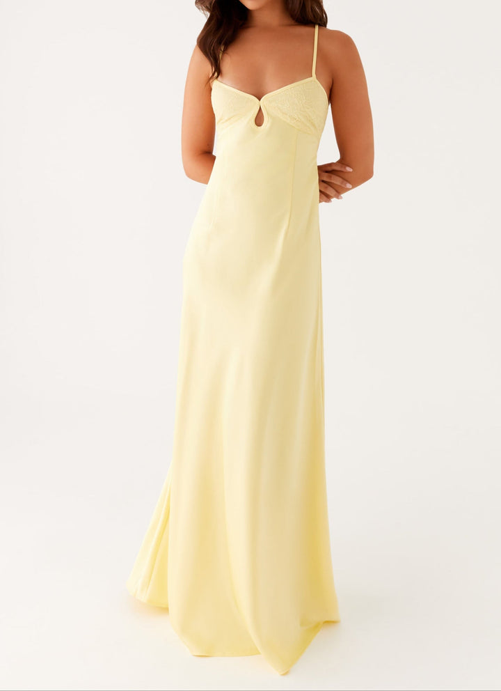 Elegant women's yellow halterneck maxi dress with sweetheart neckline, perfect for evening or formal occasions.